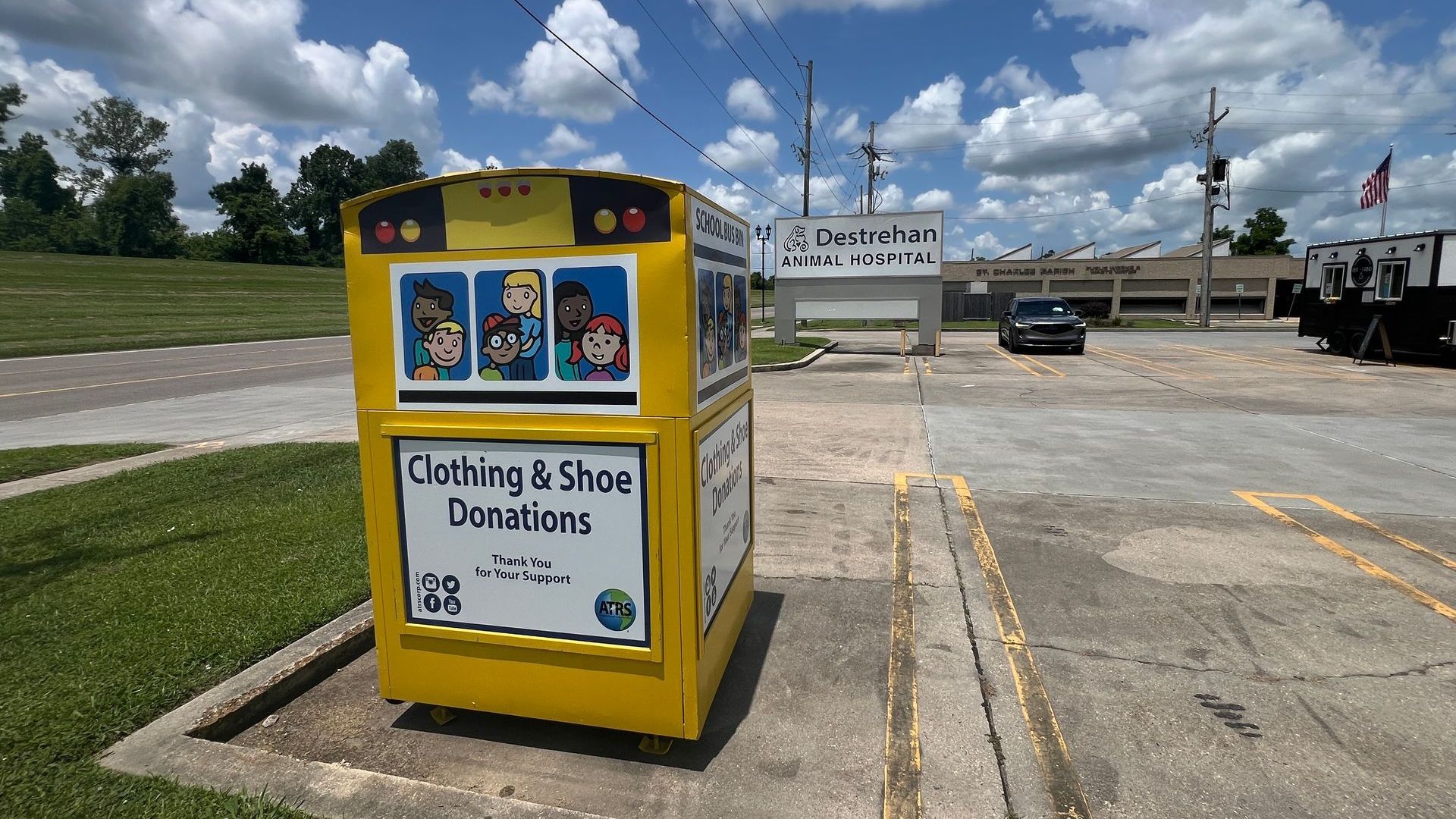 Image of clothing donation bin that looks like a yellow school bus.