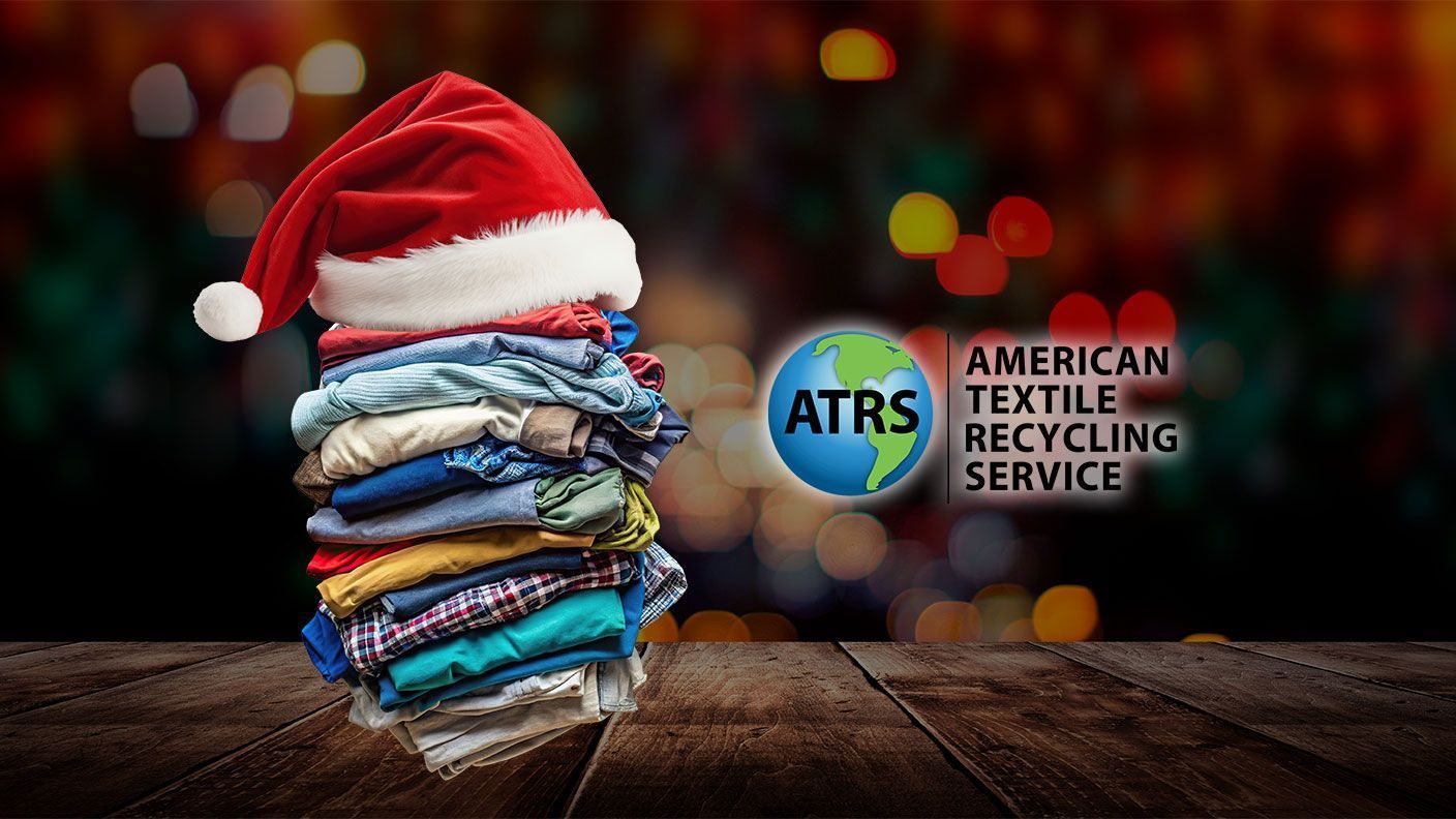 Image of stack of gently used donated clothing with a Santa hat on top, next to ATRS logo.